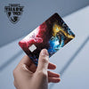 A hand holds a Magic Shark card skin sticker featuring a Dragon Ball Super Saiyan design.