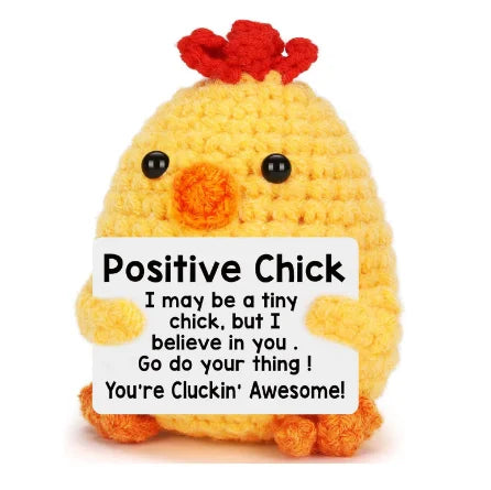 A yellow knitted plush chick with red tufts on its head.