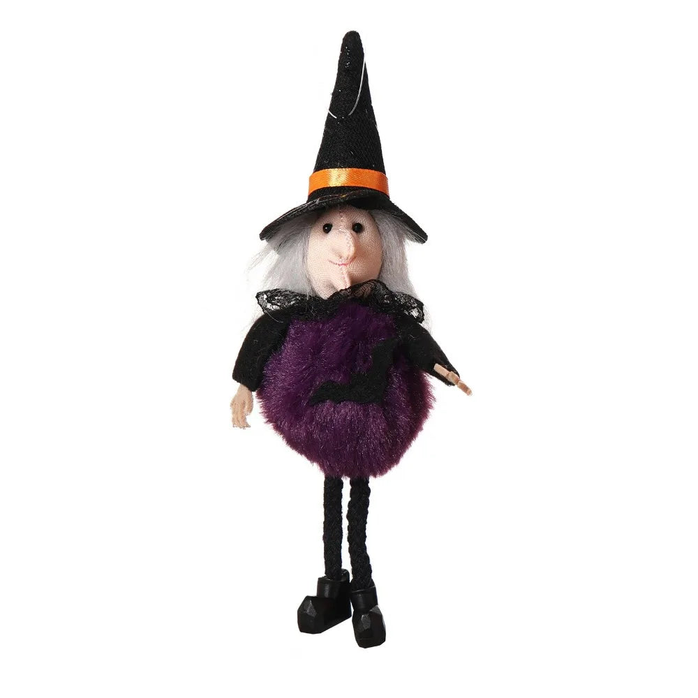 A witch ornament featuring a black pointed hat, a pale face, and a purple fuzzy body with black accents.