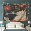 A tapestry featuring a white cat smoking under a moon, displayed as wall decor with string lights.