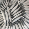 A close-up view of a refill of titanium powder for a cold spark machine, showing numerous silver-gray, cone-shaped packets.