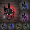 A set of vintage vinyl record guitar wall clocks displayed against a brick background.
