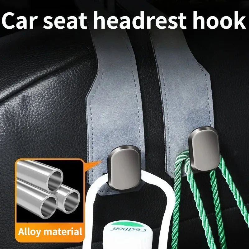 Car seat headrest hook organizer featuring an alloy core and green cord for securing items.
