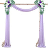 A purple chiffon wedding arch with floral greenery and purple accents draped over a wooden frame.