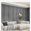 A modern living room featuring a light beige sofa and dark gray vertical wood grain wallpaper.