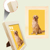 A wooden photo frame displaying a portrait of a golden retriever dog.