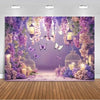 A dreamy purple butterfly photo backdrop featuring hanging lanterns, lush purple and pink floral elements, and a wooden floor