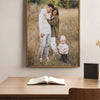 A framed photo of a father and daughter outdoors in a grassy field.