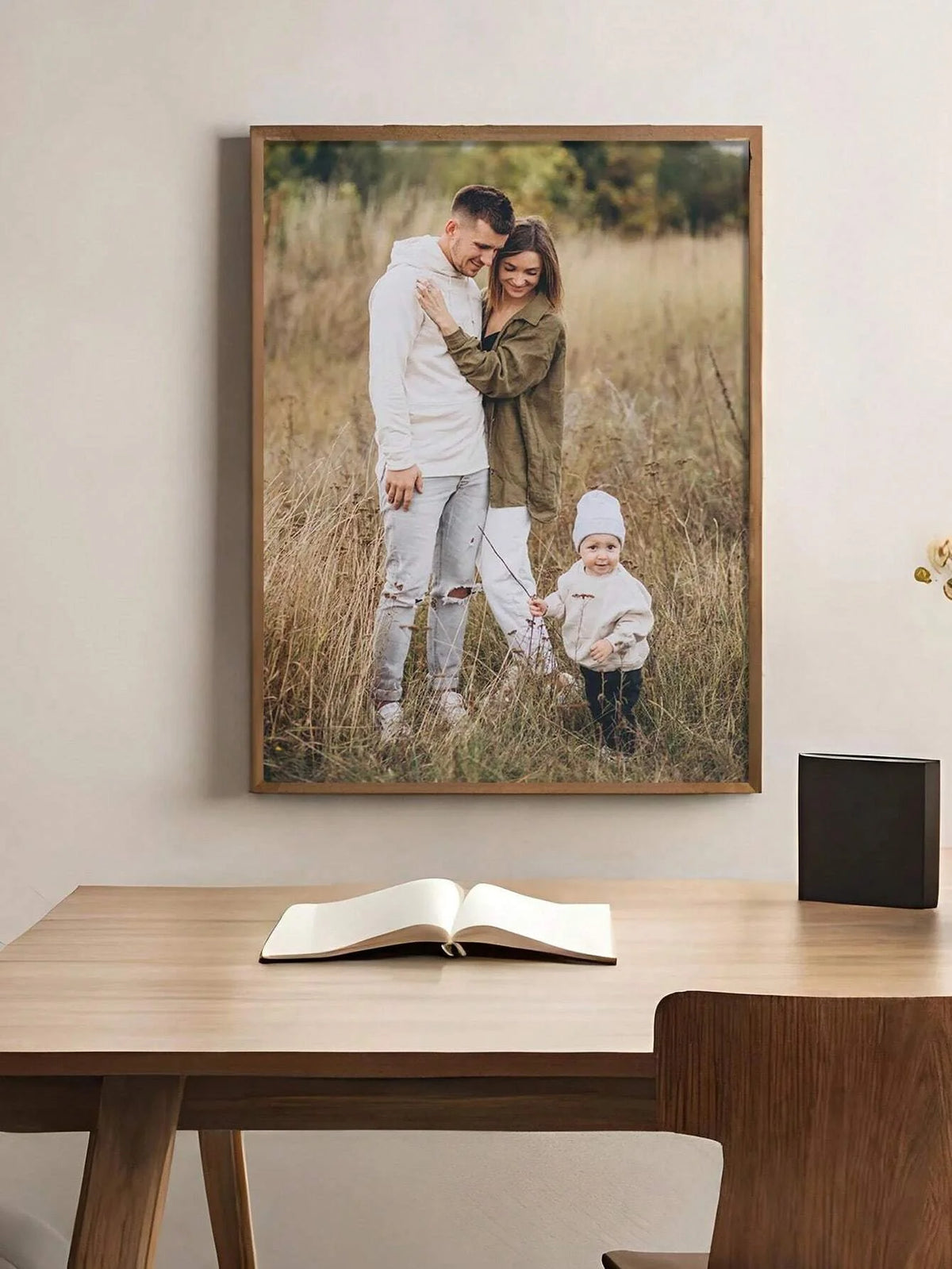 A framed photo of a father and daughter outdoors in a grassy field.