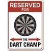 A vintage metal sign with a dartboard graphic and text that reads Reserved for The Dart Champ