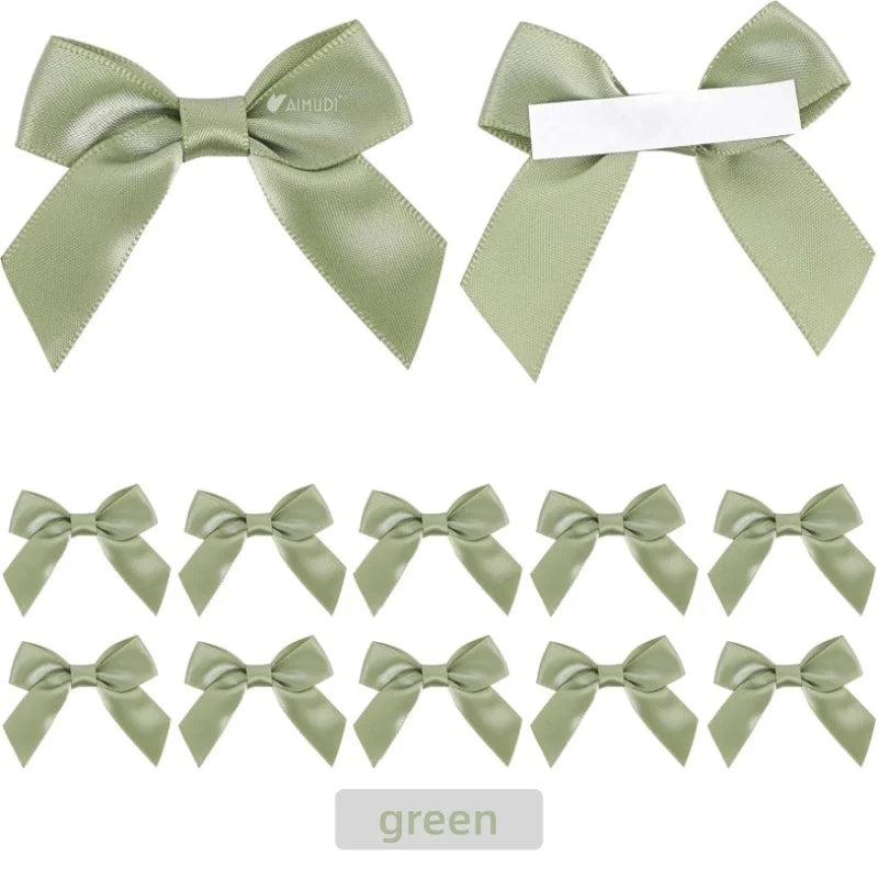 A set of green satin ribbon bows with self-adhesive backing for crafting and gift wrapping.