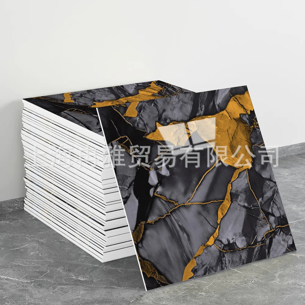A roll of faux marble 3D self-adhesive wall tiles featuring black and gold veining displayed on a gray surface.