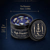 A tin candle jar labeled High Priestess containing blue crystal stones and wax.