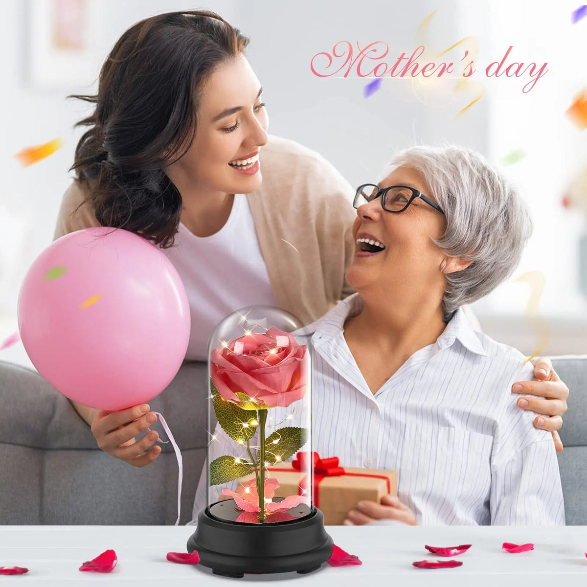 A woman is shown with a pink balloon and an eternal rose LED light simulation flower on a table.