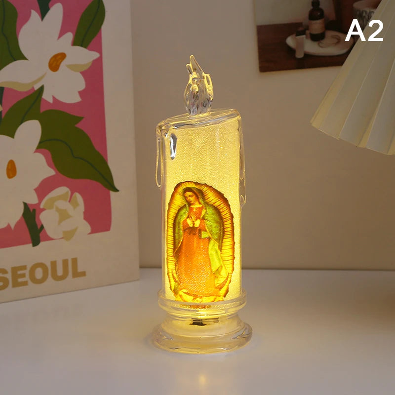 A clear glass flameless LED religious prayer candle with an orange-toned figure inside.