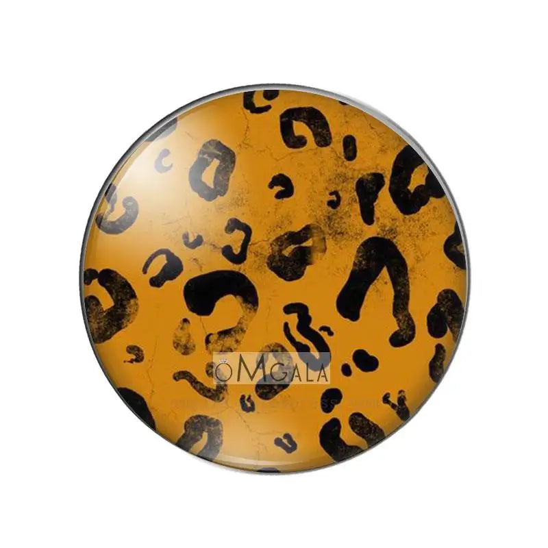 Round glass cabochon with a yellow and black leopard print pattern.