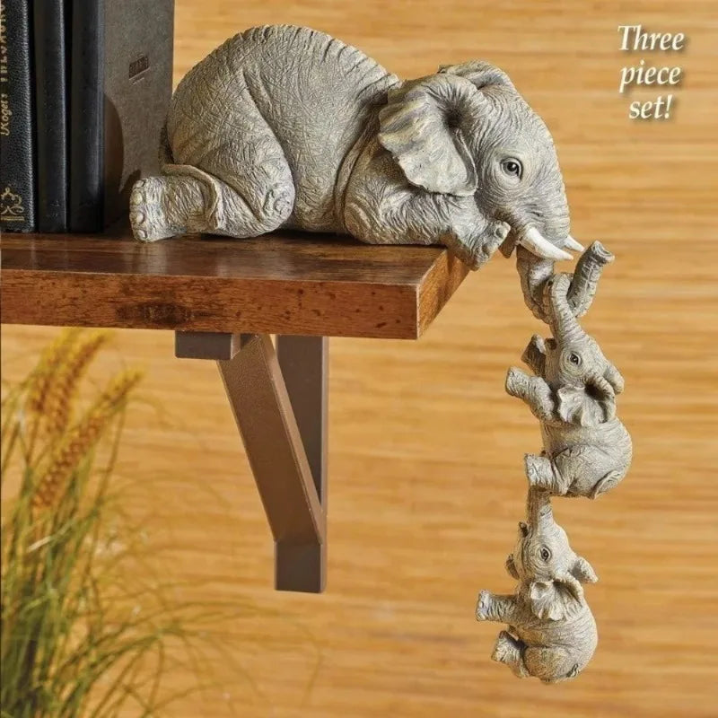 Three piece set of resin elephant figurine showing an adult elephant hugging a baby elephant