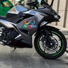 A black motorcycle with a silver fairing and an Autism awareness vinyl decal on the side panel.