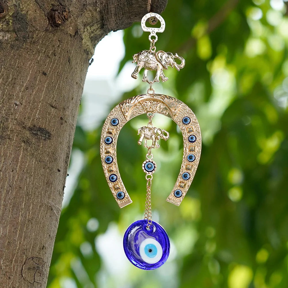 Gold and blue Turkish blue eye amulet horseshoe wall hanging with elephant charm