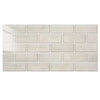 A rectangular wall of light beige glossy peel-and-stick tile stickers.