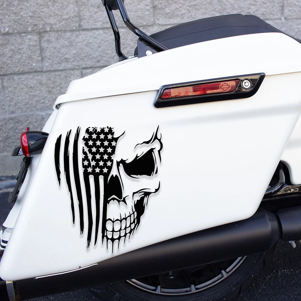 A white motorcycle features a black patriotic skull and American flag decal on the front fender.