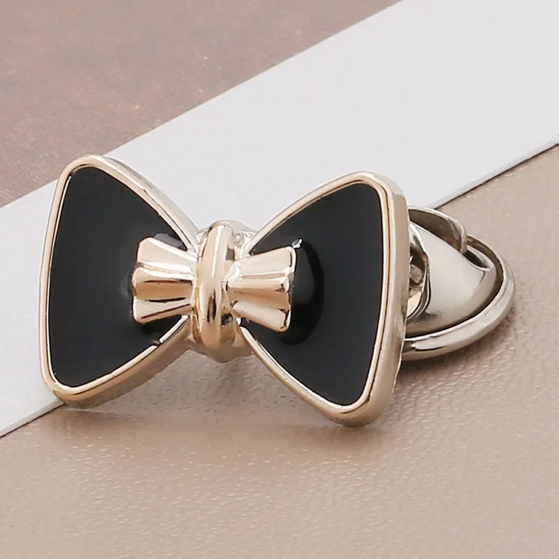 Gold-toned no-sew brooch buttons featuring black and gold accents for clothing and crafts