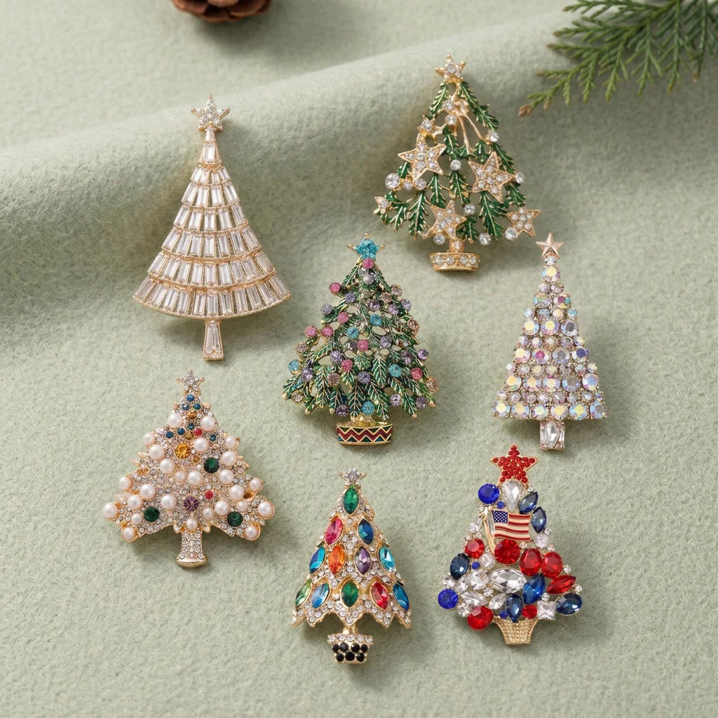 A collection of sparkling rhinestone Christmas tree brooches and pins on a light green background.