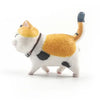 A white and orange 3D cartoon cat figurine with a black collar and tail, used as refrigerator magnets.