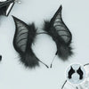 A pair of black bat simulation ears made of faux fur, displayed against a white background.