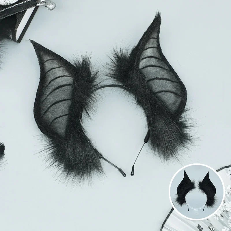 A pair of black bat simulation ears made of faux fur, displayed against a white background.
