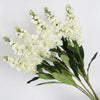 A bouquet of artificial white delphinium flowers for home decor.
