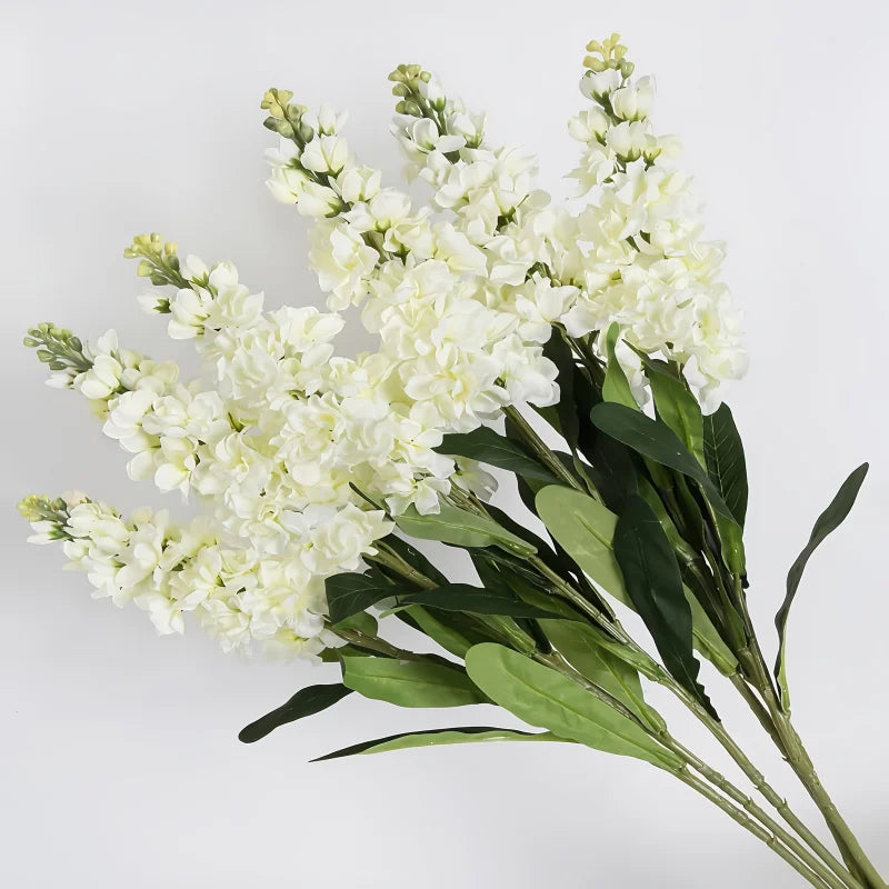 A bouquet of artificial white delphinium flowers for home decor.
