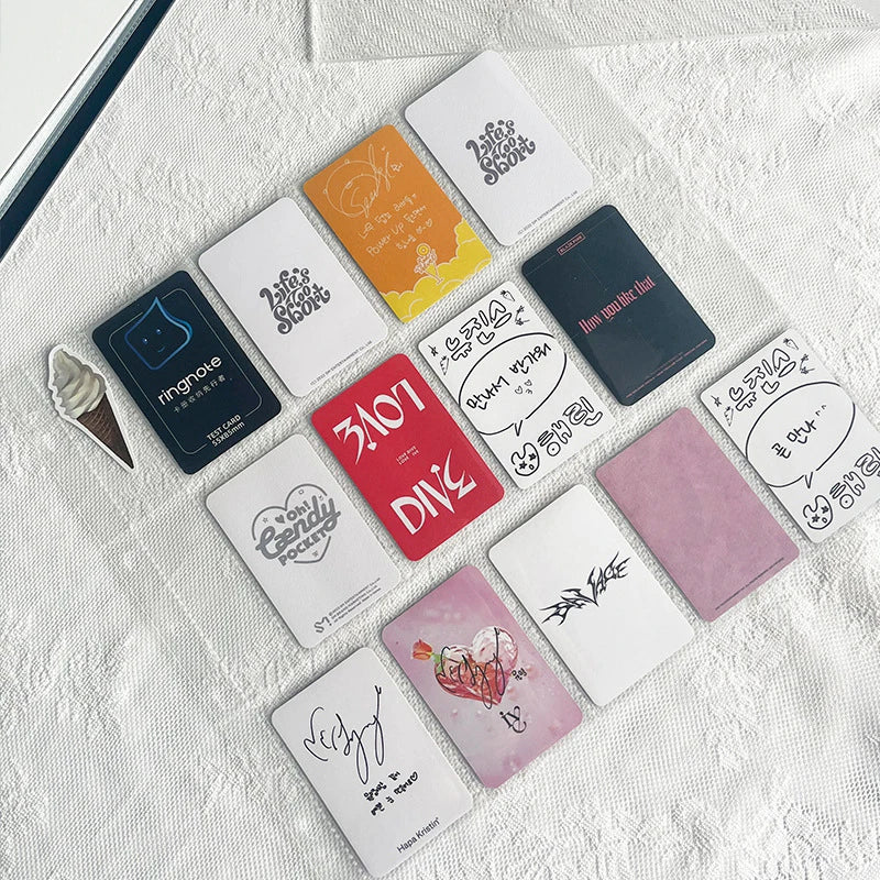 A collection of various square and rectangular grid binders and storage items for photocard collections arranged on a white t