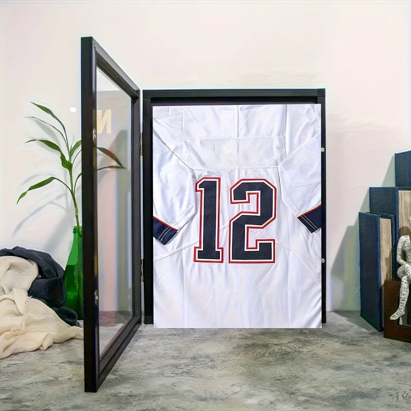 A wall-mounted wooden frame displaying a white jersey with the number 12 on a light gray wall.