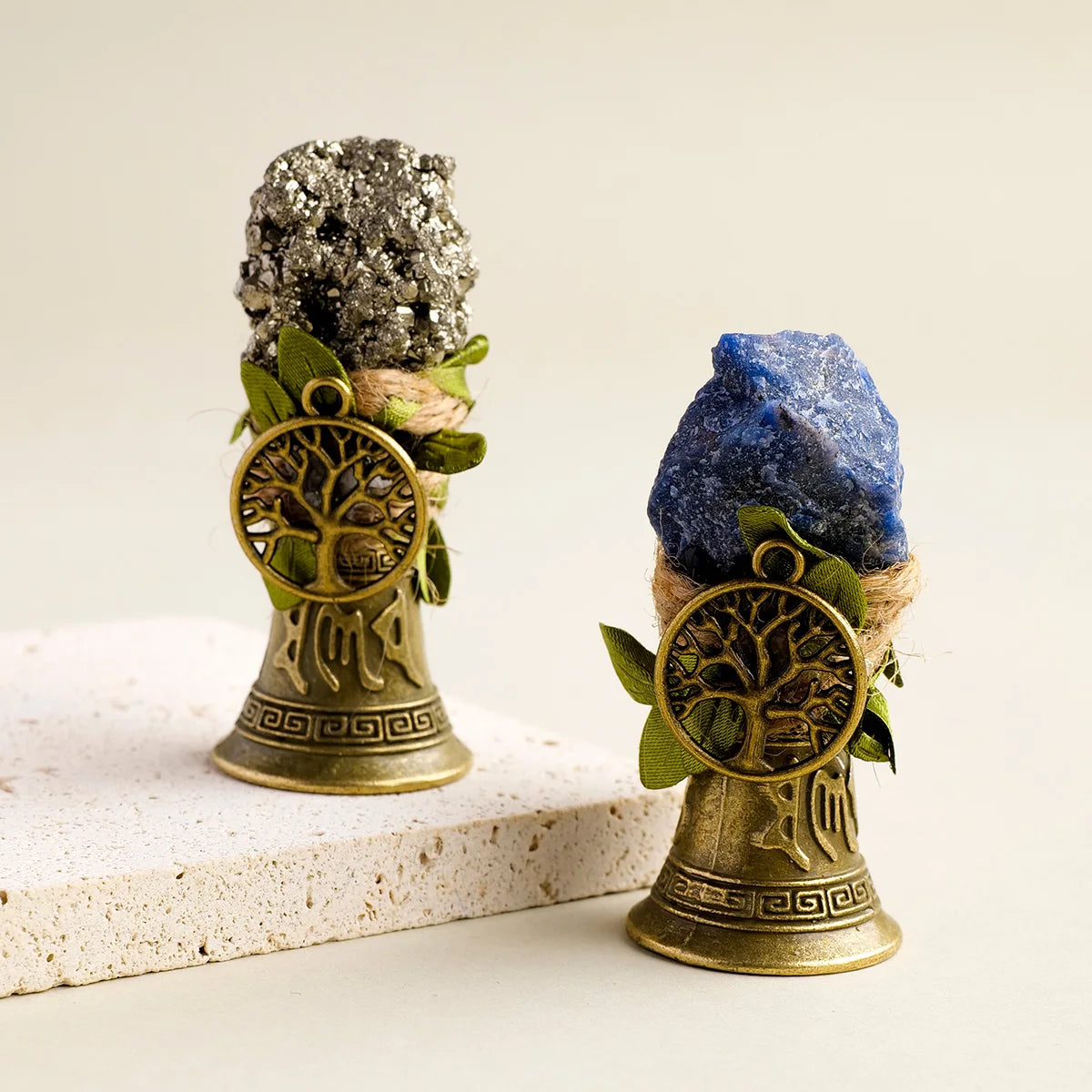 A natural crystal specimen rests in a brass bell with a copper finish.