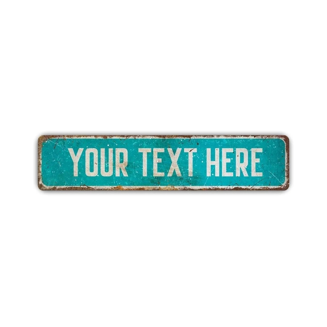 A rectangular, weathered teal aluminum sign with the text YOUR TEXT HERE.