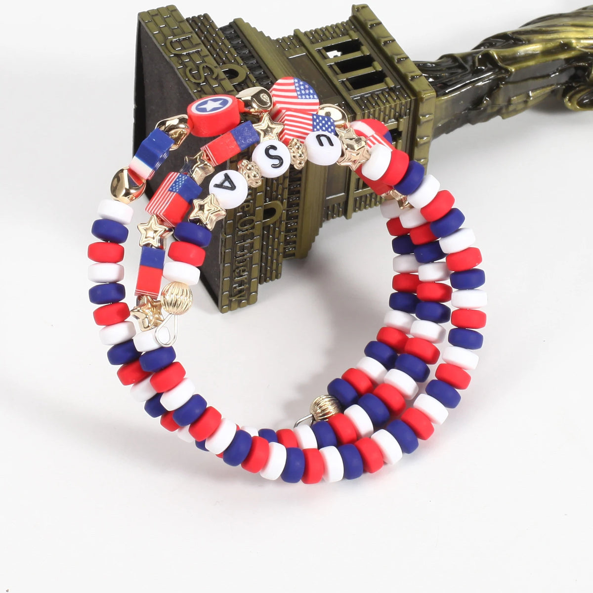 A circular bracelet made of patriotic American flag beads featuring red, white, and blue colors.