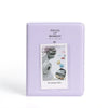 A lavender protective case for an Instax mini camera, featuring the brand name Pieces of Moment.