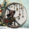 Moonlight witch stained glass window decor featuring a figure in a witch hat and dark clothing surrounded by hanging glass be