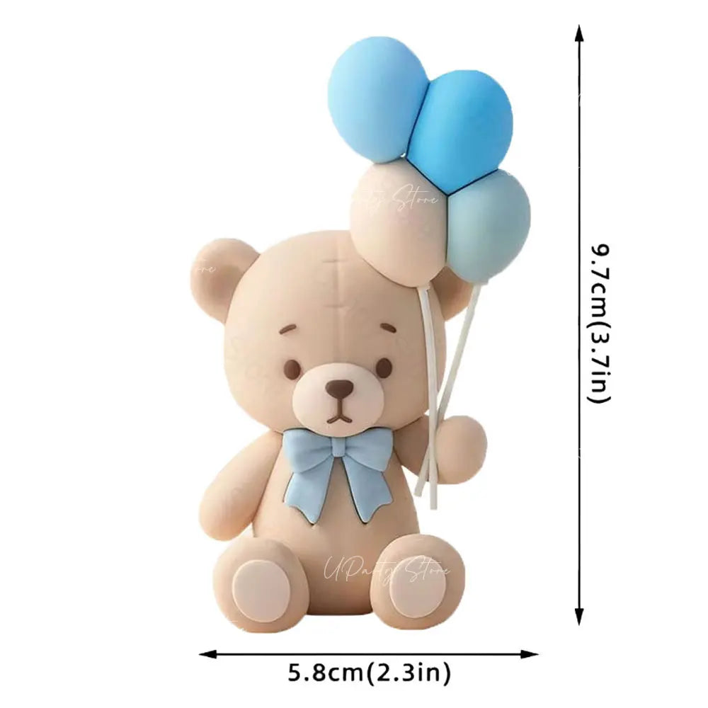 A cute, light brown teddy bear figure with blue and light blue balloon decorations.