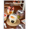 A set of 250ml plastic mousse cups with built-in spoons filled with layered fruit desserts on a wooden surface.