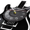 A vintage vinyl record-themed wall clock with a black face and a gold-colored hand.