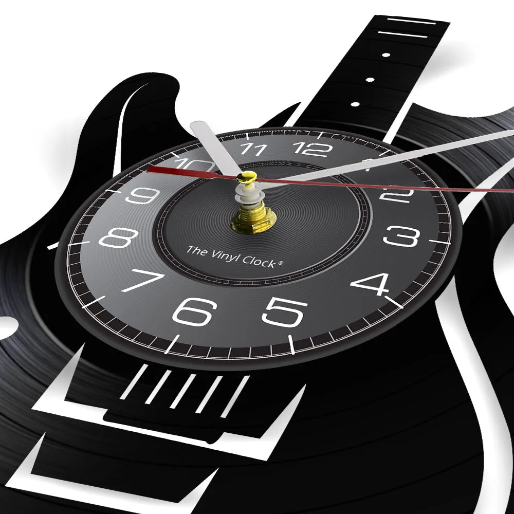 A vintage vinyl record-themed wall clock with a black face and a gold-colored hand.