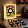 A magnetic vinyl record night light with an LED glow is displayed on a dark surface.