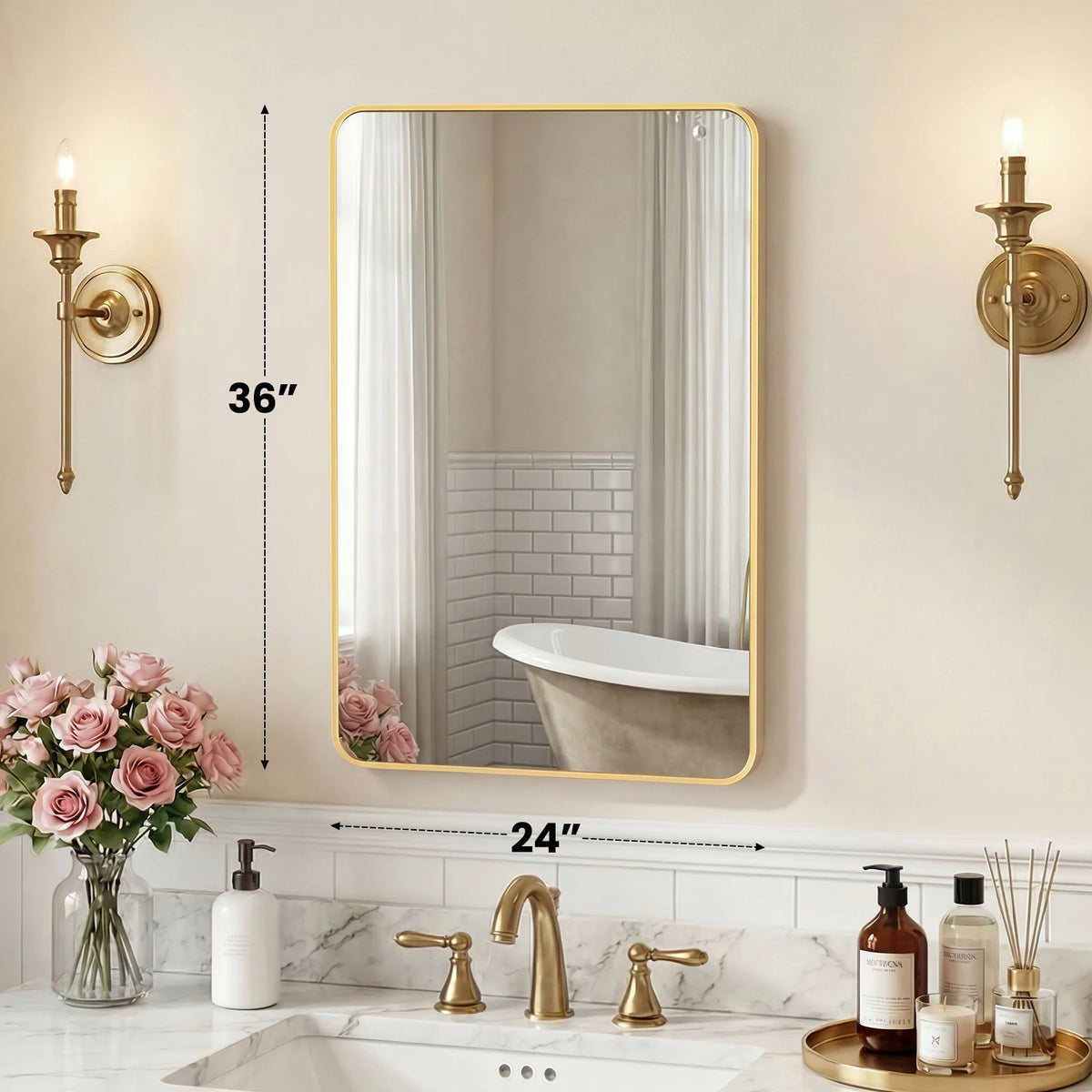 A modern wall mirror with a gold metal frame reflecting a white bathtub and a white subway tile wall.