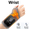 A hand wearing a black wrist device that provides heating and massage therapy.