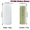A tall pillar candle mold featuring celestial and mystical symbols carved into the wax.