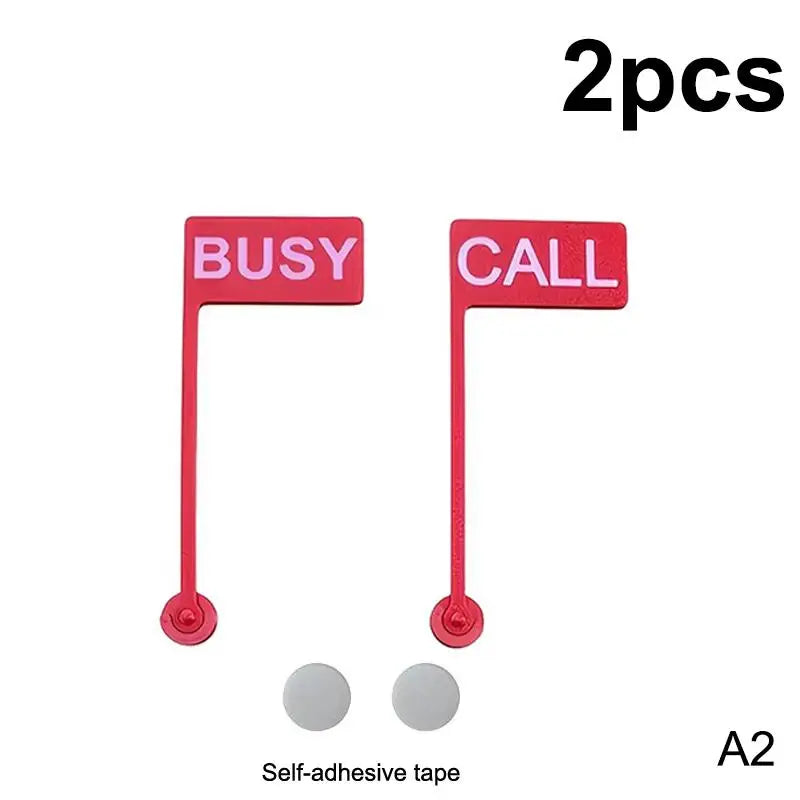 Two red desk signs labeled BUSY and CALL with adhesive tape indicators