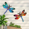 Vintage dragonfly wall art sculpture featuring iridescent blue and purple wings mounted on a white wooden panel.