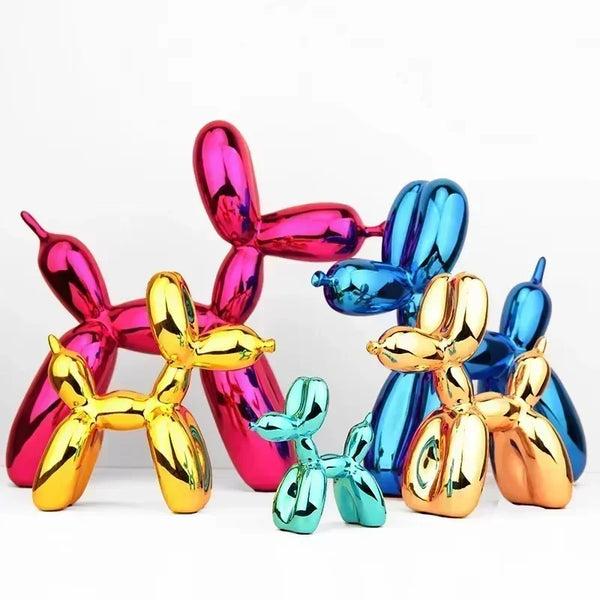 A collection of colorful resin balloon dog sculptures in pink, purple, blue, and gold.